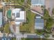 Aerial view of backyard oasis featuring a pool, lush landscaping, patio, and outdoor living spaces at 2900 S Peninsula Dr, Daytona Beach, FL 32118