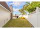 Backyard featuring a patio area with outdoor seating, a grill, and a kayak, enclosed by a white fence at 2900 S Peninsula Dr, Daytona Beach, FL 32118