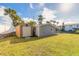 Backyard featuring a shed and finished bonus room with air conditioning and a screened-in porch at 2900 S Peninsula Dr, Daytona Beach, FL 32118