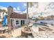 Backyard pool and patio with outdoor dining set and privacy fence at 2900 S Peninsula Dr, Daytona Beach, FL 32118