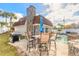 Backyard pool and patio with outdoor dining set and barbecue grill at 2900 S Peninsula Dr, Daytona Beach, FL 32118