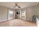 Bright bedroom with two windows, ceiling fan, and stylish accent chairs at 2900 S Peninsula Dr, Daytona Beach, FL 32118