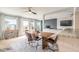 Dining area showcasing a rustic wood table, modern chairs, and a glimpse into the cozy living room at 2900 S Peninsula Dr, Daytona Beach, FL 32118
