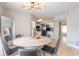 Bright dining room with a modern chandelier, round table, and view into the updated kitchen area at 2900 S Peninsula Dr, Daytona Beach, FL 32118
