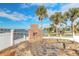 Outdoor brick firepit with stone surround overlooking the water and palm trees at 2900 S Peninsula Dr, Daytona Beach, FL 32118