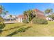 Home exterior featuring lush, mature landscaping and a neatly manicured lawn at 2900 S Peninsula Dr, Daytona Beach, FL 32118