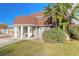 Home exterior with mature landscaping, a well-manicured lawn, and a brick-lined driveway at 2900 S Peninsula Dr, Daytona Beach, FL 32118