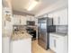 Modern kitchen featuring stainless steel appliances, granite countertops, and white cabinets at 2900 S Peninsula Dr, Daytona Beach, FL 32118