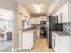 Updated kitchen featuring white cabinets, granite countertops, stainless steel appliances, and modern fixtures at 2900 S Peninsula Dr, Daytona Beach, FL 32118