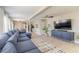 Open living room with a sectional couch, ceiling fan, and views into the dining area and kitchen at 2900 S Peninsula Dr, Daytona Beach, FL 32118