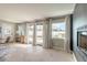 Bright living space with a view of the outdoor canal through large windows and a modern fireplace at 2900 S Peninsula Dr, Daytona Beach, FL 32118