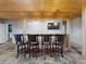 Basement bar with a wooden countertop, TV, pendant lights, and bar stools at 2950 Sunset Dr, New Smyrna Beach, FL 32168