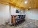 Basement bar with a wooden countertop, TV, lights, and tile flooring at 2950 Sunset Dr, New Smyrna Beach, FL 32168
