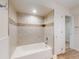 Bathroom featuring bathtub and tiled shower with neutral wall color at 2950 Sunset Dr, New Smyrna Beach, FL 32168