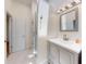 Bathroom featuring updated vanity and glass enclosed shower and door to bedroom at 2950 Sunset Dr, New Smyrna Beach, FL 32168
