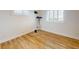 Smaller bedroom with wood floors, shuttered windows and wall-mounted entertainment center at 2950 Sunset Dr, New Smyrna Beach, FL 32168