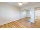 Bedroom with sliding door closet, wood floors, and entry to another room at 2950 Sunset Dr, New Smyrna Beach, FL 32168