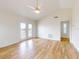 Spacious bedroom with wood-look floors, vaulted ceiling, fan and access to a balcony at 2950 Sunset Dr, New Smyrna Beach, FL 32168