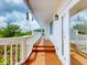 Inviting deck with steps leading up, offering a cozy outdoor retreat with decorative hanging ornaments at 2950 Sunset Dr, New Smyrna Beach, FL 32168