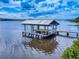 Private dock featuring covered seating and scenic waterfront views on a sunny day at 2950 Sunset Dr, New Smyrna Beach, FL 32168