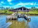 Waterfront boat dock featuring a lounging area and hammock, creating a serene setting at 2950 Sunset Dr, New Smyrna Beach, FL 32168