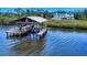 Private dock with covered area near a home offering easy access to the water at 2950 Sunset Dr, New Smyrna Beach, FL 32168