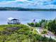 Picturesque dock featuring a boat lift on a serene waterfront setting with lush greenery at 2950 Sunset Dr, New Smyrna Beach, FL 32168