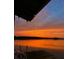 Dock over the water featuring a beautiful sunset at 2950 Sunset Dr, New Smyrna Beach, FL 32168