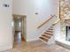 Bright entryway features wood-look flooring, staircase, and hallway leading to a room with a window at 2950 Sunset Dr, New Smyrna Beach, FL 32168