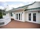 Back view showing a spacious wooden deck and multiple french doors opening to a private outdoor area at 2950 Sunset Dr, New Smyrna Beach, FL 32168