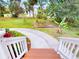 Inviting front yard with a curved driveway, verdant lawn, and carefully designed garden beds at 2950 Sunset Dr, New Smyrna Beach, FL 32168