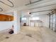 Spacious garage with storage cabinets, work bench, and potential for parking or hobbies at 2950 Sunset Dr, New Smyrna Beach, FL 32168