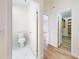 Hallway view with an open door to a bathroom and a walk-in closet with shelving at 2950 Sunset Dr, New Smyrna Beach, FL 32168