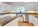 Kitchen showcases granite countertops, a stainless steel sink, and modern stainless steel appliances at 2950 Sunset Dr, New Smyrna Beach, FL 32168