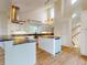 Well-lit kitchen with white cabinets, granite countertops, stainless steel appliances, and vaulted ceilings at 2950 Sunset Dr, New Smyrna Beach, FL 32168