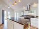Kitchen boasts stainless steel appliances, granite countertops, a central island, and a breakfast bar at 2950 Sunset Dr, New Smyrna Beach, FL 32168
