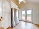 Kitchen area featuring stainless steel refrigerator, custom cabinets, and a french door to a deck at 2950 Sunset Dr, New Smyrna Beach, FL 32168