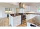 Kitchen includes stainless steel appliances, custom cabinetry, and granite countertops at 2950 Sunset Dr, New Smyrna Beach, FL 32168