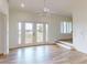 Bright and airy living room with wood floors, ceiling fan, and deck access offering great views of the outdoors at 2950 Sunset Dr, New Smyrna Beach, FL 32168