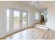 Stylish living room with wood floors and deck access, featuring a decorative fireplace and ample natural light at 2950 Sunset Dr, New Smyrna Beach, FL 32168