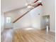 Spacious living room with wood-look floors, a high ceiling with fan, and natural light from the windows at 2950 Sunset Dr, New Smyrna Beach, FL 32168