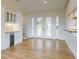 Open living area with wood floors, mini bar, and French doors to deck with stunning views and bright natural light at 2950 Sunset Dr, New Smyrna Beach, FL 32168