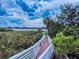 Inviting wooden walkway through lush vegetation leads to serene waterfront property at 2950 Sunset Dr, New Smyrna Beach, FL 32168