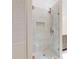 Luxurious glass shower with gray vanity, rainfall shower head, and built-in niche at 2950 Sunset Dr, New Smyrna Beach, FL 32168