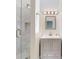 Elegant shower with a rainfall shower head, built-in niche, and stylish vanity at 2950 Sunset Dr, New Smyrna Beach, FL 32168