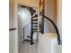 View of metal spiral staircase with wooden treads and a tile floor at 2950 Sunset Dr, New Smyrna Beach, FL 32168