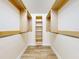 Spacious walk-in closet with custom wooden shelves and hanging rods offers lots of storage space at 2950 Sunset Dr, New Smyrna Beach, FL 32168