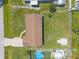 Aerial of home with large lot, garage, storage shed, fenced yard and round pool at 3044 Pine Tree Dr, Edgewater, FL 32141