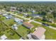 Overhead image of a neighborhood with single-Gathering homes, showcasing mature trees and well-kept lawns at 3044 Pine Tree Dr, Edgewater, FL 32141
