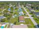 Aerial view of the home, highlighting its well-maintained lawn, fenced backyard, and the community neighborhood at 3044 Pine Tree Dr, Edgewater, FL 32141